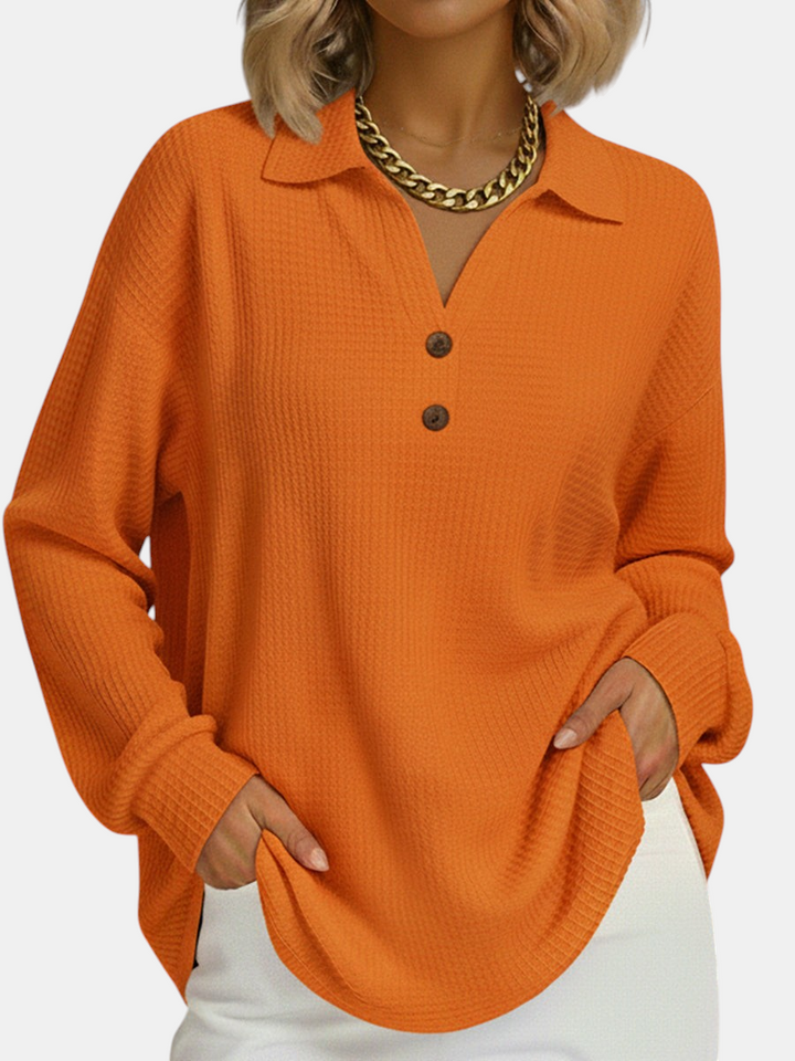 Margaret Dublin orange loose-fit sweatshirt with polo collar, buttons and waffle texture, ideal for cooler days.