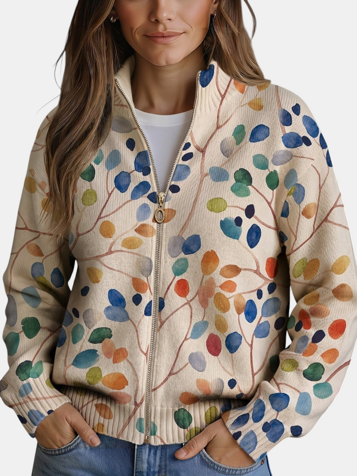 Cardigan de malha Margaret Dublin com padrão de folhas coloridas, fecho dourado e corte bomber em tons creme.